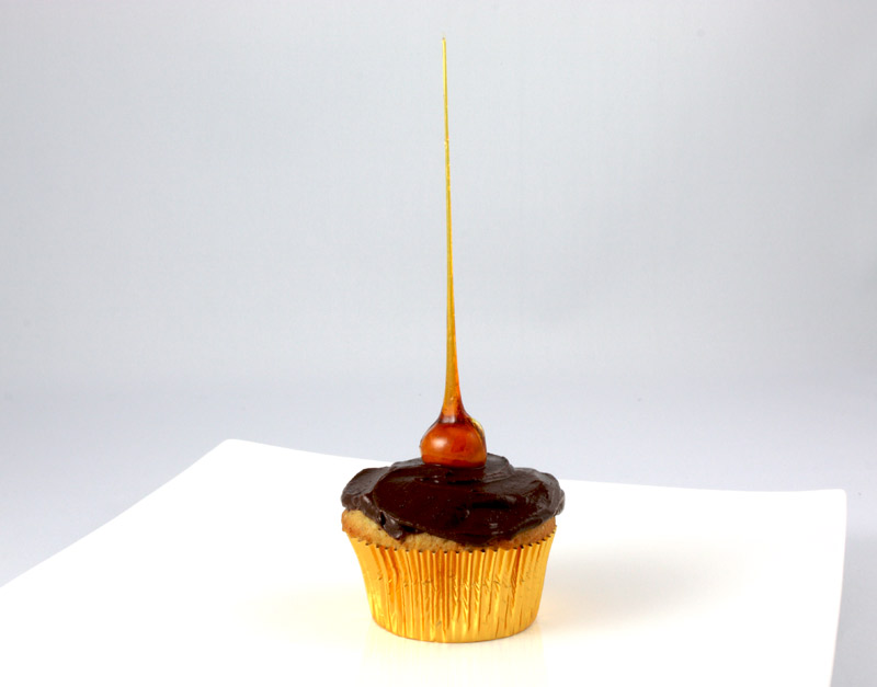 Candied-Hazelnut Cupcakes A close up photo of a candied-hazelnut cupcake on a white plate.