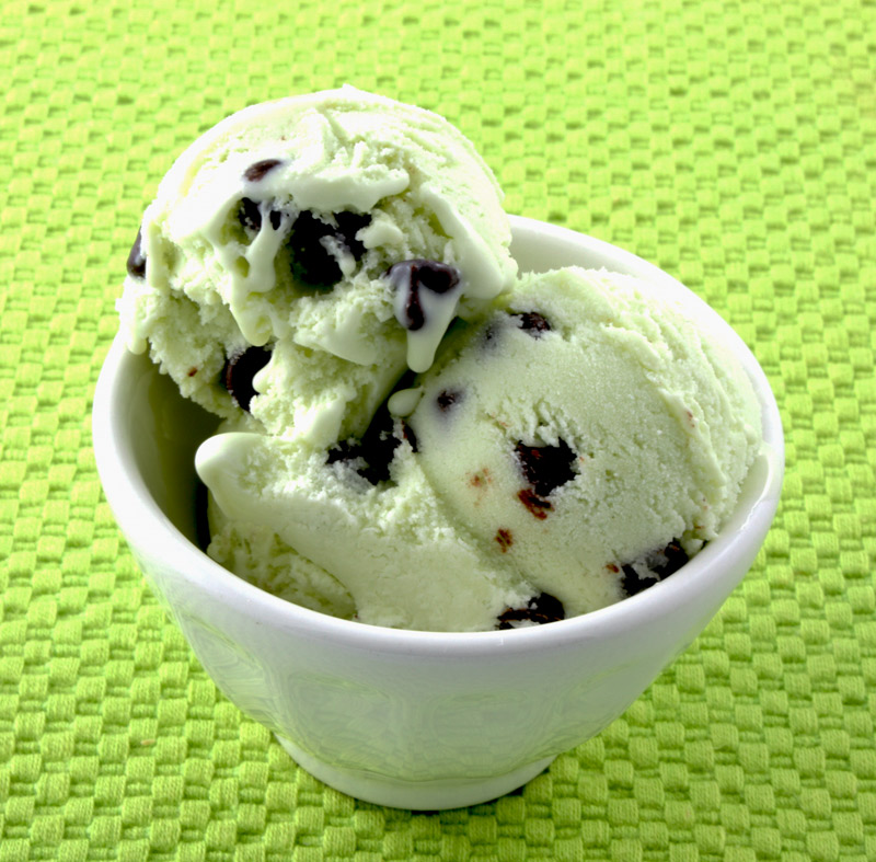 Mint Chocolate Chip Ice Cream A photo of mint chocolate ice cream in a white bowl on a green placemat.