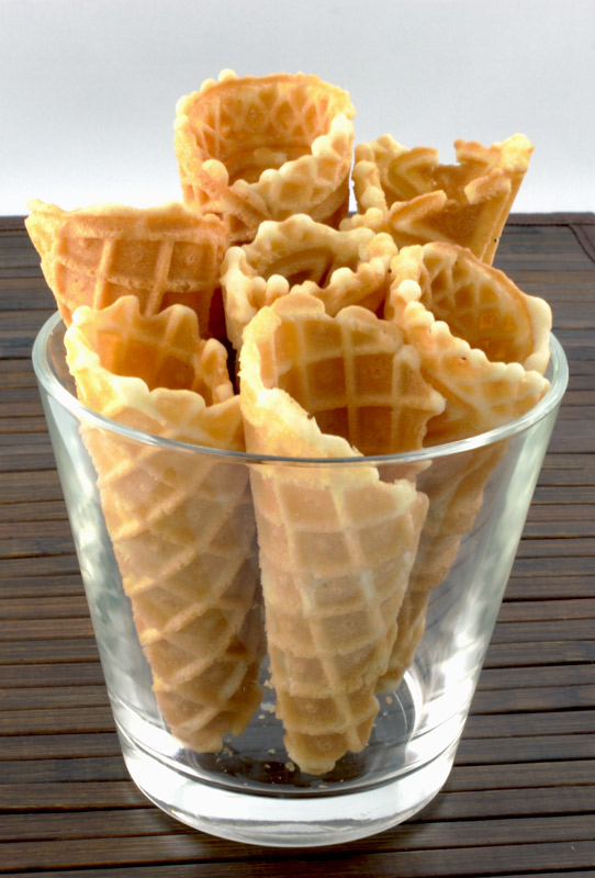 Waffle Cones A photo of waffle cones in a glass bowl on a wooden placemat.