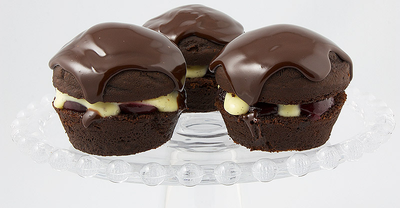 Martha Stewart's Black Forest Cupcakes A photo of 3 black forest cupcakes on a glass cake stand.