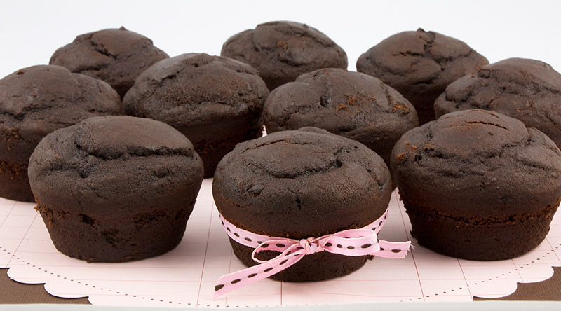 Martha Stewart's Black Forest Cupcakes A photo of black forest cupcakes, one with a pink ribbon a pink and brown sheet of paper.