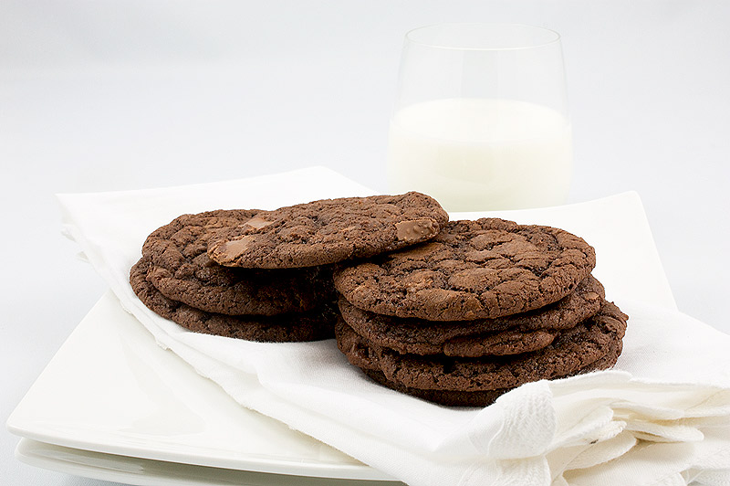 double-chocolate chunk cookies, recipe for double-chocolate chunk cookies, Martha Stewart double-chocolate chunk cookies, easy recipe for double chocolate cookies A photo of 8 double-chocolate chunk cookies on a white linen napkin placed on a white dish.
