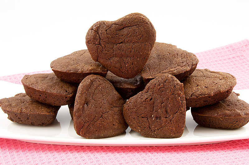 mini heart-shaped brownies, one-bowl brownies, one bowl brownies recipe, Martha Stewart's brownie hearts recipe A photo of a dish of mini chocolate brownie hearts placed on a pink napkin.