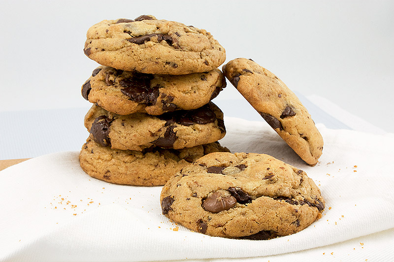 Jacques Torres's secret chocolate chip cookie recipe, Jacques Torres's recipe for chocolate chip cookies, bakery style chocolate chip cookies A photo of a stack of Jacques Torres's Secret Chocolate Chip Cookies placed on a white napkin.