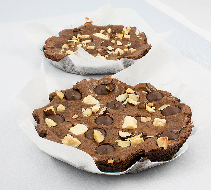 Robert Steinberg's absolute best brownies recipe, easy chocolate dessert recipes, easy brownie recipes A photo of 3 small skillet sized brownies lined with parchment.