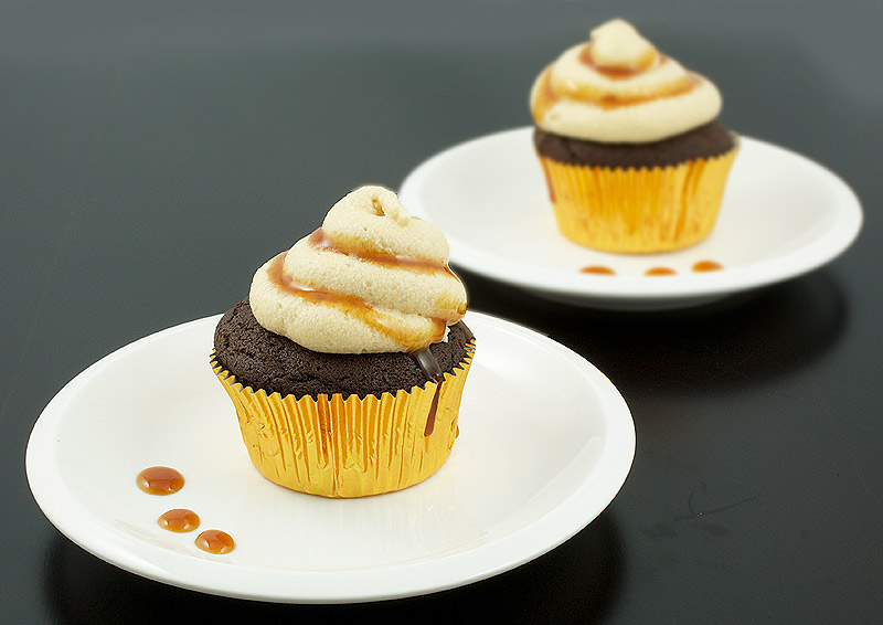caramel buttercream frosting, quick and easy cupcakes, boozy cupcakes A photo of 2 Caramilk® Cream-Vodka Cooler Cupcakes with Caramel Buttercream Frosting, each on a dessert plate.