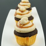 caramel buttercream frosting, quick and easy cupcakes, boozy cupcakes A photo of 3 Caramilk® Cream-Vodka Cooler Cupcakes with Caramel Buttercream Icing.
