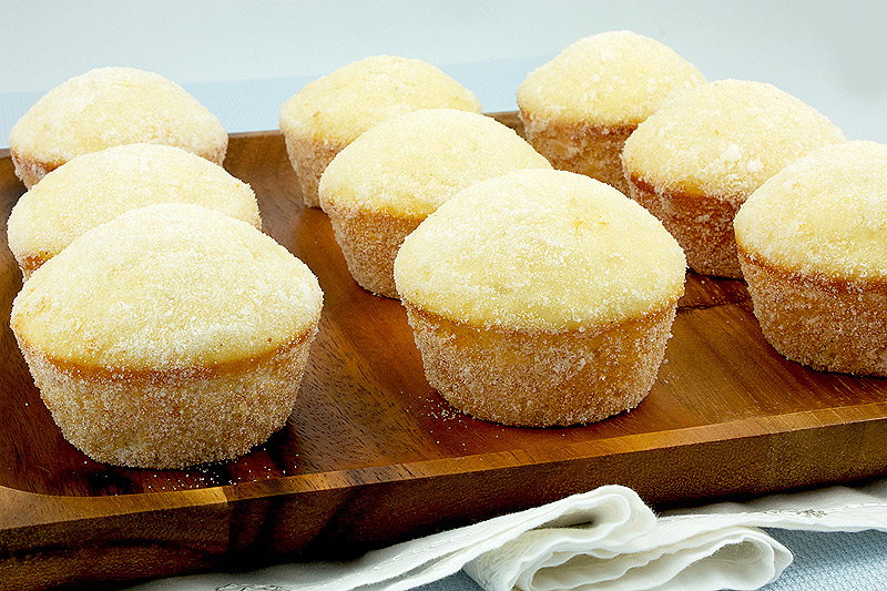 breakfast ideas, easy chocolate recipes, chocolate muffin recipes A photo of Sugar Donut Muffins arranged on a wooden platter placed on a white cloth napkin.
