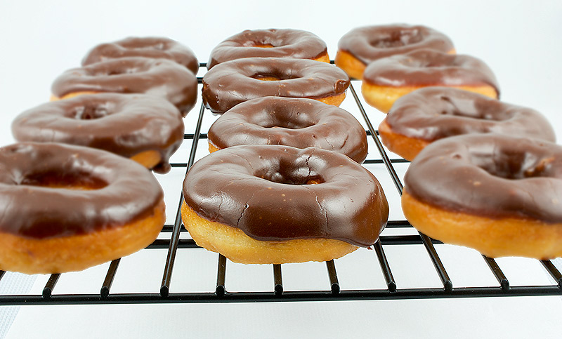 doughnut holes, Donna Hay recipes, yeast doughnut recipe A photo of chocolate glazed doughnuts cooling on a wire rack.