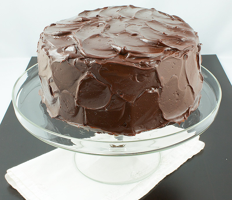 recipe for salted candied peanuts, how to make salted candied peanuts, how to make easy ganache frosting A photo taken looking down on David Lebovitz's Banana Cake with Mocha Frosting displayed on a glass cake stand.