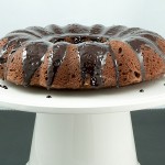 Donna Hay's Butterscotch-Glazed Chocolate Bundt Cake A photo of Donna Hay's Butterscotch-Glazed Chocolate Bundt Cake displayed on a white cake stand.