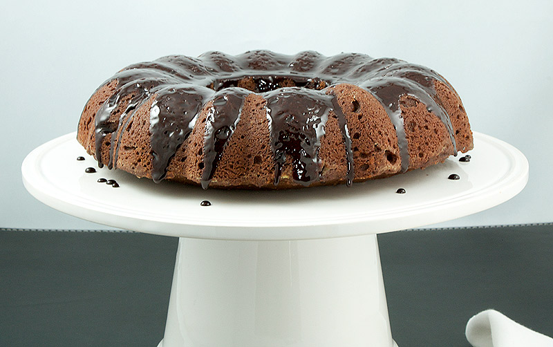 Donna Hay's Butterscotch-Glazed Chocolate Bundt Cake A photo of Donna Hay's Butterscotch-Glazed Chocolate Bundt Cake displayed on a white cake stand.