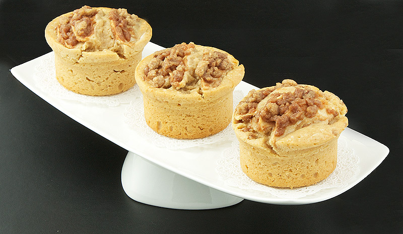crumb coffee cake, easy apple cake, calvados recipe, easy apple desserts A photo of Donna Hay's Warm Apple Cinnamon Crumb Cakes with Calvados on a white pedestal plate.