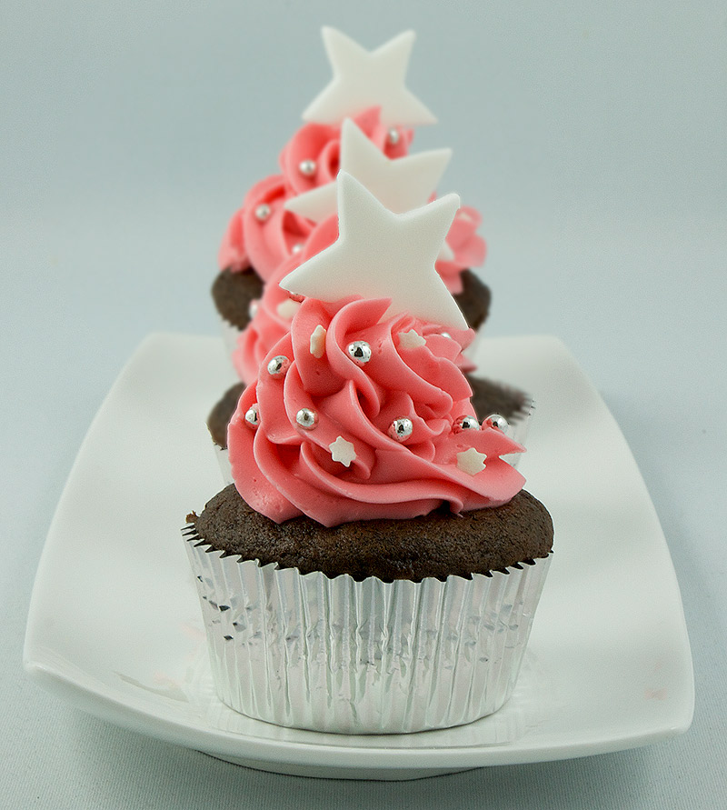 Dark Chocolate Cupcakes with Peppermint Marshmallow Cream Filling A photo of 3 Dark Chocolate Cupcakes with Peppermint Marshmallow Cream Filling topped with Swiss Meringue Buttercream frosting.