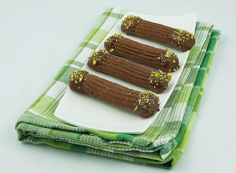 chocolate spritz cookies, spritz cookies, Christmas spritz cookies A photo of Chocolate-Hazelnut Spritz Cookies dipped in luscious chocolate and sprinkled with nuts.