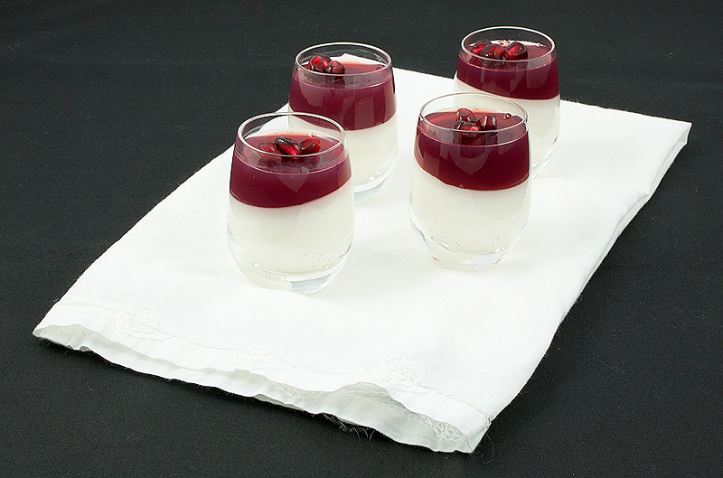 easy Italian desserts, Italian panna cotta, Italian dessert recipes A photo of Vanilla-Coconut Panna Cotta with Pomegranate Jelly desserts on a white napkin.