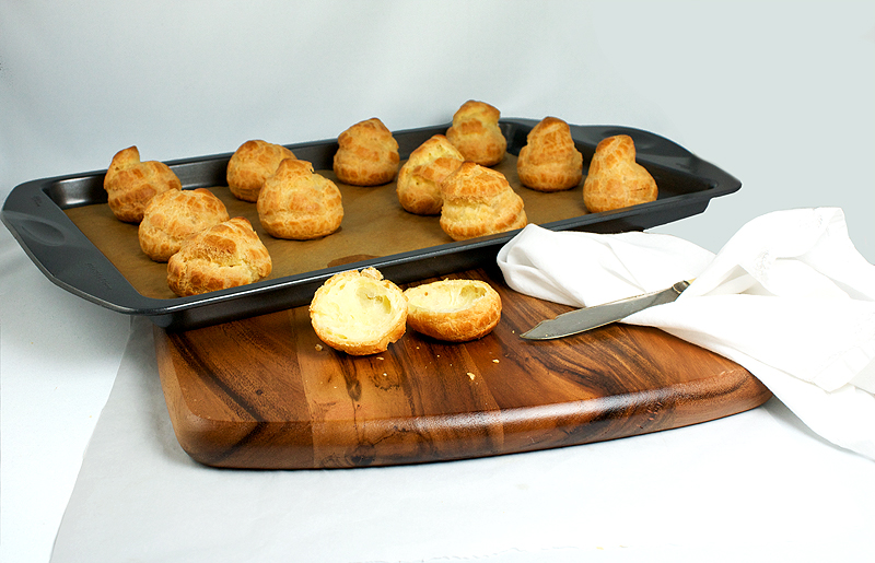 Pâte à Choux Puffs (Choux Pastry Puffs) A photo of Pâte à Choux Puffs (Choux Pastry Puffs) on a wooden cutting board.