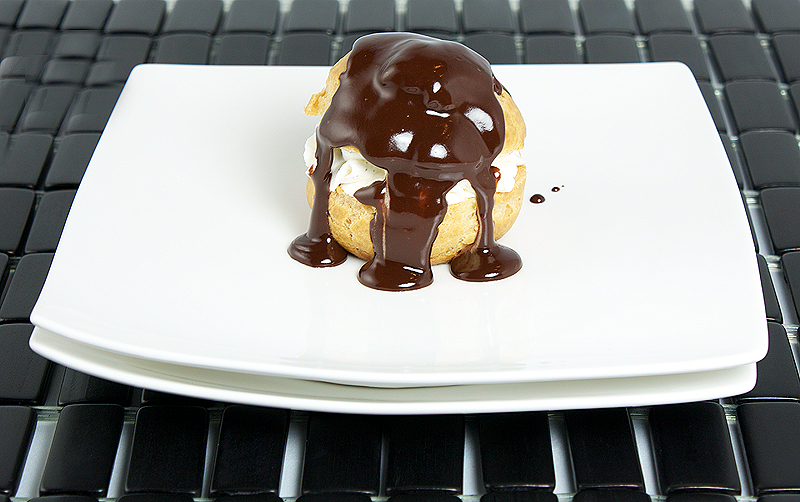 Profiterole with Vanilla Chantilly Cream and Hot Chocolate Sauce A photo of a Profiterole with Vanilla Chantilly Cream and drizzled with Hot Chocolate Sauce.