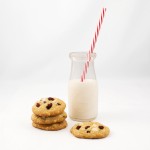 White Chocolate, Cranberry and Hazelnut Cookies A photo of a glass of Milk with White Chocolate, Cranberry and Hazelnut Cookies.