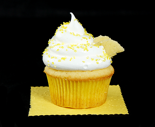 Honey-Kissed Yellow Cupcakes with Meringue Icing A close up photo of a Honey-Kissed Yellow Cupcake with Meringue Icing.