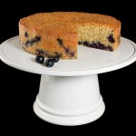 Almond Cake A photo of an Almond Cake with Blueberries on a white cake stand.