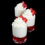 Strawberry Shortcake Trifle A photo of 3 Strawberry Shortcake Trifle desserts garnished with fresh strawberries.