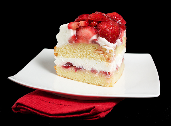 Strawberry and Cream Cake A photo of a slice of Strawberry and Cream Cake served on a white dessert dish.