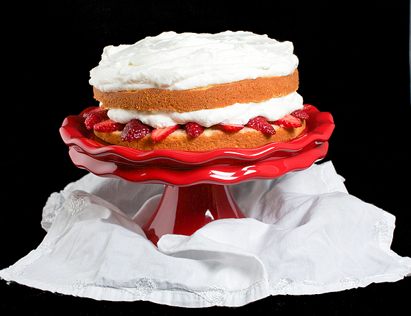 Strawberry Cream Cake A photo of Strawberry Cream Cake on a red cake stand.