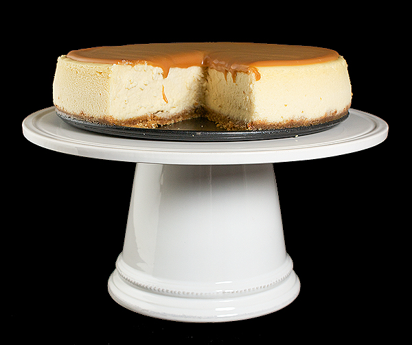 make a cheesecake, recipe for caramel sauce, cheesecake recipe, best cheesecake recipe A photo of an Amaretto Cheesecake with Amaretto-Caramel Sauce with a sliced removed and displayed on a cake stand.
