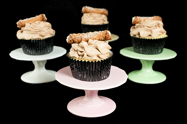 gourmet cupcake recipes, cupcake gourmet, Italian Desserts A photo of Cannoli Cupcakes with Chocolate Whipped Cream and decorated with mini Cannoli displayed on multi coloured mini cupcake stands.