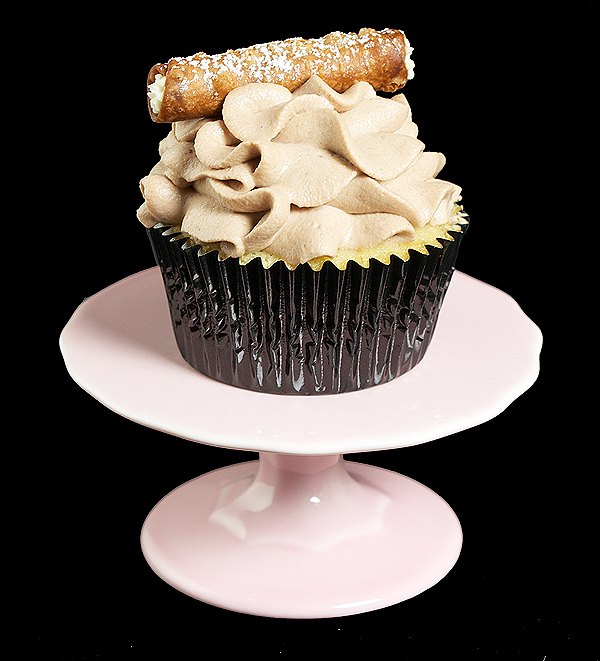 Cannoli Cupcakes A photo of a Cannoli Cupcake displayed on a pink, mini cupcake stand.