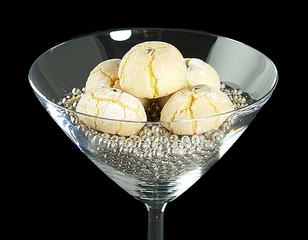 Amaretti Cookies A photo of Amaretti on a bed of silver dragees in a martini glass.