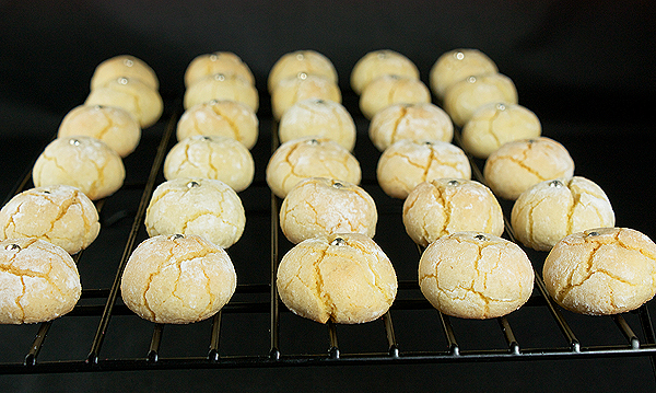 Italian Cookies A photo of Italian Cookies, Amaretti, cooling on a black wire rack.