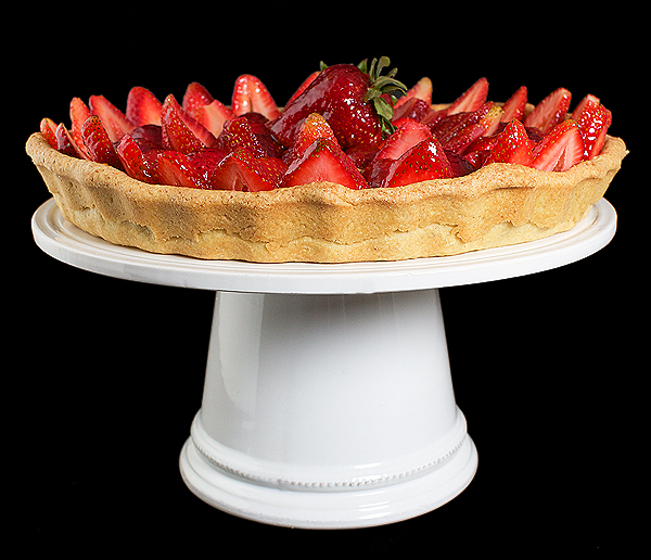 A photo of an Italian Cake, Torta di Fragole made with a Hazelnut Pasta Frolla and filled with Crema Pasticcera, topped with fresh strawberries and a thin coating of Grand Marnier-Apricot Glaze.