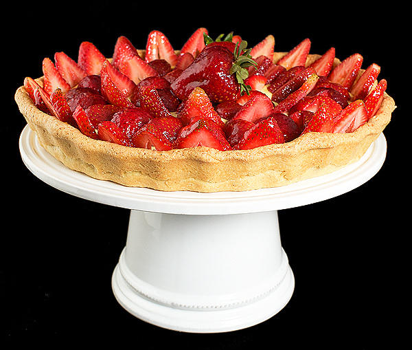 A photo of an Italian Fruit Tart filled with Crema Pasticcera and topped with fresh strawberries coated with a Grand Marnier-Apricot Glaze.