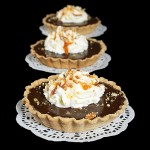 Chocolate-Caramel Tart {Tartellette al Cioccolato e Caramello} A photo of Italian Desserts, Tartellette al Cioccolato e Caramello (Chocolate-Caramel Tarts) presented on white doilies.