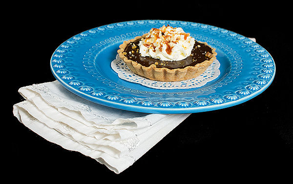 Caramel Tarts A photo of a Chocolate-Caramel Tart on a blue dessert dish.