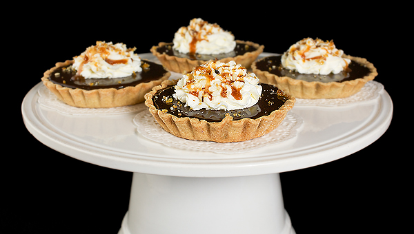 caramel tart, caramel sauce recipe, caramel sauce A photo of Chocolate Tarts with a layer of caramel and toasted hazelnuts, topped with whipped cream, caramel sauce and hazelnut praline.