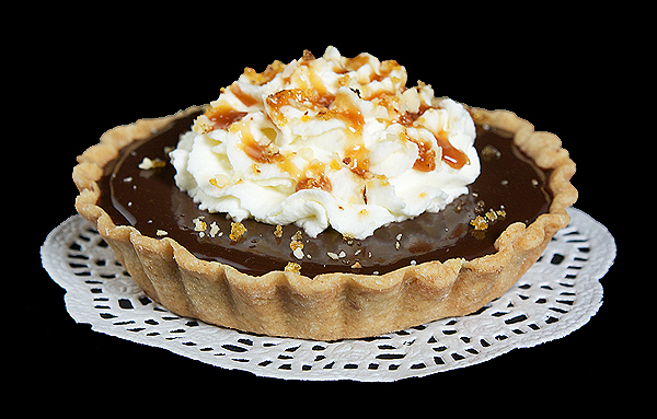 Chocolate-Caramel Tart {Tartellette al Cioccolato e Caramello} A photo of a Chocolate-Caramel Tart {Tartellette al Cioccolato e Caramello} on a white doilie.