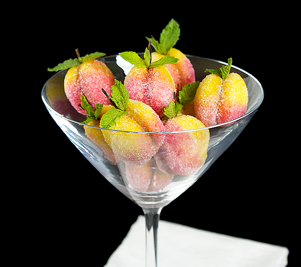 Pesche A close up photo of Italian Cookies, Mini Pesche Dolci, displayed in a martini glass.
