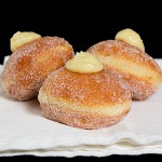 A photo of Bomboloni alla Crema, Italian Cream-Filled Donuts.