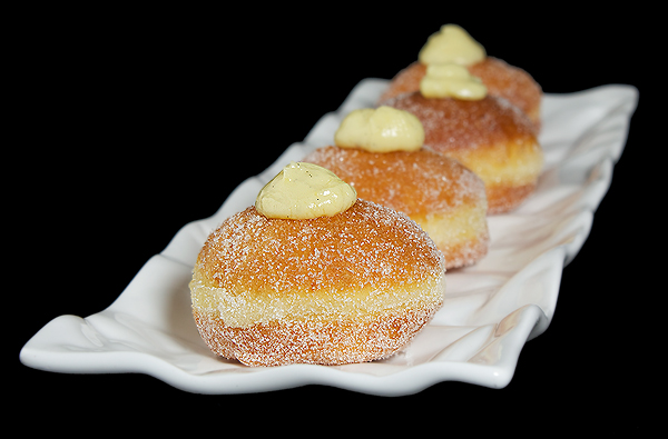 Italian Donuts A photo of Italian Pastries, Bomboloni displayed on a white rectangular dish.