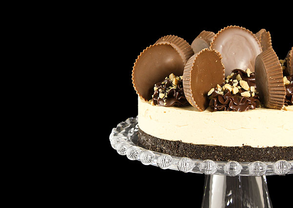 Grace's Sweet Life Reese's Peanut Butter Cake A cropped photo of a Reese's Peanut Butter Cake on a glass cake stand.