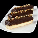 A photo of Salt Caramel dessert, Chocolate Caramel Cookie Bars displayed on a white dish.
