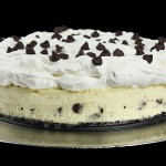 Grace's Sweet Life Cheesecake Toppings A photo of A Chocolate Chip Cheesecake with a Whipped Cream Topping decorated with dark chocolate chips.