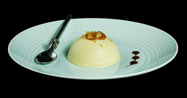 Grace's Sweet Life Parfait A photo of an Italian Parfait with salted caramel and hazelnut praline on a blue dish with a dessert spoon.