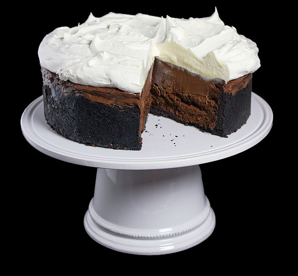 Mississippi Mudpie A photo of a Mississippi Mudpie with a slice removed displayed on a white cake stand.