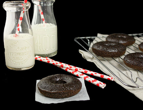 Baked Donuts from Grace's Sweet Life A cropped photo of baked donuts and two small bottles of milk with red polka dot straws.