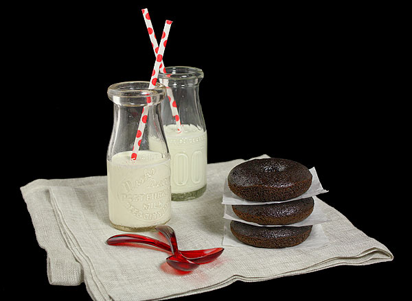 Cake Donuts from Grace's Sweet Life A photo of a stack of three chocolate Cake Donuts served with small bottles of milk.