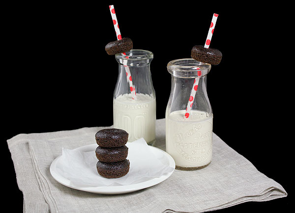 Grace's Sweet Life Mini Cake Donuts A photo of two bottles of milk with red polka dot straws with Mini Cake Donuts threaded on the straws displayed with a plate of mini chocolate cake donuts set in front.